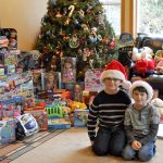 Ryan Downey, left, and Zachary Darner, right, sit surrounded by may of the toys they collected for their Kids Helping Kids toy drive.                                Michelle Beahm / Kitsap News Group
