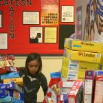 Students add newly donated boxes of cereal to the collection in the View Ridge Elementary lobby.                                Michelle Beahm / Kitsap News Group