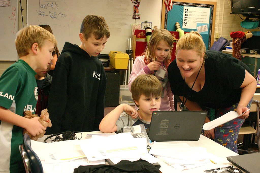 Kathryn Sprague, right, and her students update the tally of donated cereal boxes Monday, Dec. 12. The total count when they finished was 607 boxes of cereal.                                Michelle Beahm / Kitsap News Group