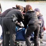 Emergency personnel prepare a person&rsquo;s body for transport, Dec. 8 at Brownsville Marina. (Terryl Asla/Kitsap News Group)