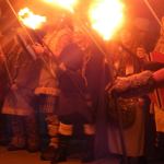 Faces glow from the torch light during the Julefest celebration, Dec. 3 at Muriel Iverson Williams Waterfront Park. (Angie Donovan/Kitsap News Group correspondent)