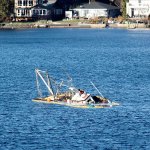 Approximately 250 gallons of fuel were removed Dec. 12 from a vessel that broke away from its anchor chain, drifted ashore and beached in Apple Tree Cove. (Sophie Bonomi / Kitsap Daily News)