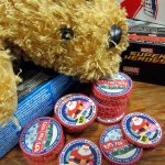 Above left, challenge coins &mdash; a military tradition &mdash; are presented to Toys for Tots volunteers. Above, Marines in dress uniforms doff their covers and get down to work with volunteers from the Marine Corps League.                                 Terryl Asla/Kitsap News Group