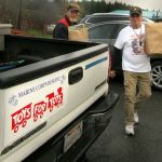 Gunny helps unload another pick-up load of toys. Terryl Asla/Kitsap Daily News