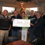 Sons of Norway lodge President Glen Robbins, with hand raised, calls Al Aicher and Tina McFee of ShareNet to join the photo Dec. 16 at the lodge. The lodge donated $6,200 and food and toys to ShareNet. (Richard Walker/Kitsap News Group)