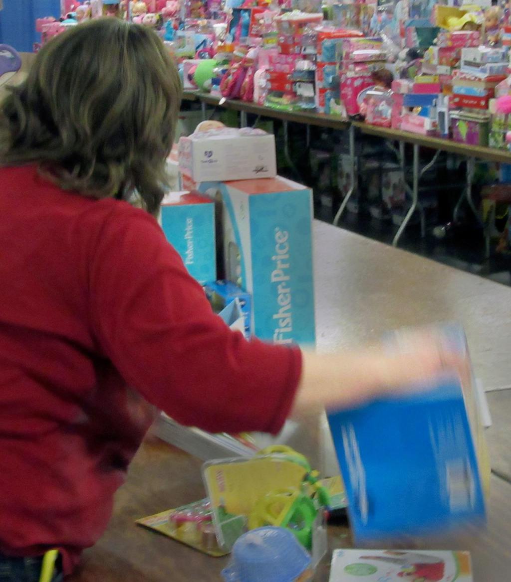 Volunteers sort and count the toys as they come in. Terryl Asla/Kitsap Daily News