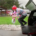 &ldquo;One pink bike!&rdquo; Volunteer unloads one of four brand-new bicycles that were donated by a family. Terryl Asla/Kitsap Daily News