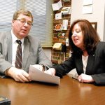 Greg Wall, South Kitsap School District board president, and Tracy Patterson, assistant superintendent of business services, review documents pertaining to the upcoming school bond measure before voters Feb. 14.                                Bob Smith | Kitsap Daily News