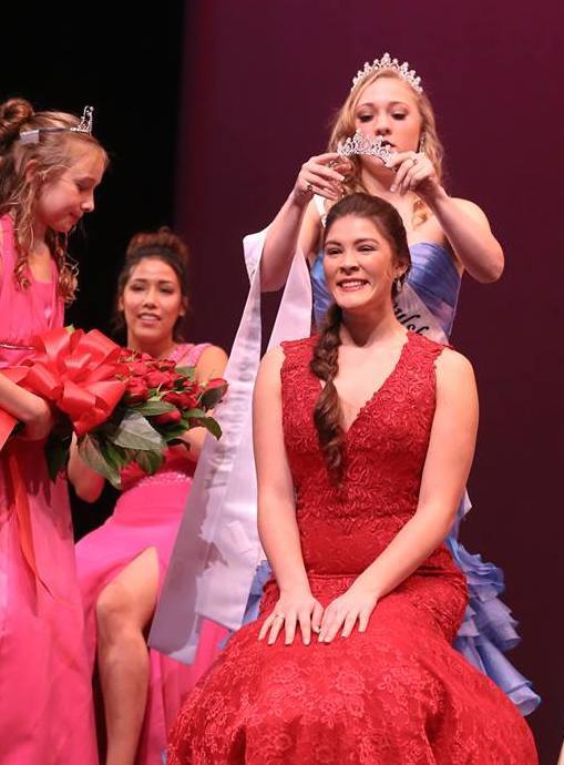 Miss Poulsbo Caroline Atkins receives her title crown from her predecessor, Kaitlyn Morrell. Olympic Photo Group