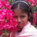 A girl named Wendy poses with flowers in this image from the Ometepe children&rsquo;s photography project.                                 Courtesy / Bainbridge Ometepe Sister Island Association