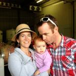 Cinder Wines co-owners Melanie Krause and Joe Schnerr hold their daughter, Sam, at the winery in Garden City, Idaho. (Andy Perdue/Great Northwest Wine)