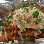 One of Wiley&rsquo;s Home Cooking Food Truck&rsquo;s many comfort dishes with a twist: The kitchen sink with sweet potato fries, smothered turkey, grated cheese, fried egg and cilantro.                                Courtesy of Willie Mae Sharpe
