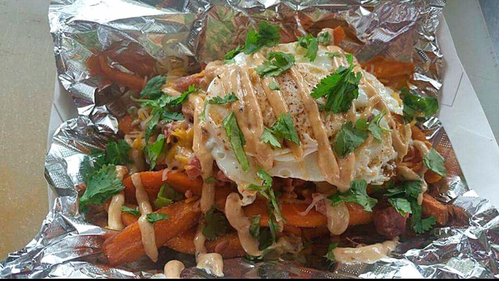 One of Wiley&rsquo;s Home Cooking Food Truck&rsquo;s many comfort dishes with a twist: The kitchen sink with sweet potato fries, smothered turkey, grated cheese, fried egg and cilantro.                                Courtesy of Willie Mae Sharpe