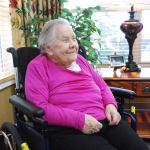 Nonchalant centenarian enjoying life surrounded by loving family