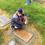 Tiger Cub Tristan Crittenden of Den 1, Pack 5239 chartered to VFW Post 239, places a flag upon the grave of Staff Sergeant Paul A. Linder, US Army, World War II at Miller-Woodlawn Cemetery on May 23, 2015, in honor of Memorial Day. Photo courtesy Keith Ciancio