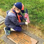Tiger Cub Tristan Crittenden of Den 1, Pack 5239 chartered to VFW Post 239, places a flag upon the grave of Staff Sergeant Paul A. Linder, US Army, World War II at Miller-Woodlawn Cemetery on May 23, 2015, in honor of Memorial Day. Photo courtesy Keith Ciancio
