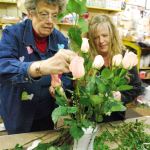 Hundreds of arrangements, mainly red roses, will leave Lavonne Lynam&rsquo;s Gazebo Florist shop on Feb. 14 for Valentine&rsquo;s Day. Assistant Nicole Schmittler is at the right of Lynam. Photo credit: Bob Smith | Kitsap Daily News