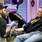 Paul Weaver tattoos Chelsey Freeman with flash art. Michelle Beahm / Kitsap News Group