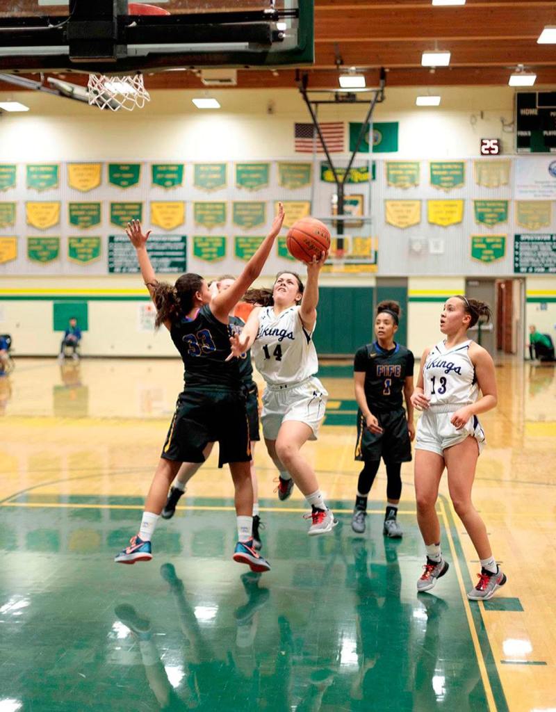 North Kitsap freshman Noey Barreith looks for an opening in the Vikings&rsquo; winning game against Fife Feb. 11. (Harry McConnell / Contributed)