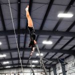 Kingston sophomore all-around Mikka Yamane performs a giant on high bar during the Port Angeles quad meet Jan. 16. Sheila Moore / Submitted