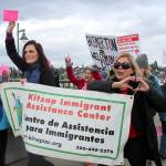 Representatives of the Kitsap Immigrant Assistance Center at the Kitsap Builds Bridges, Not Walls vigil Feb. 25. KIAC is an important resource for the local immigrant community.                                Michelle Beahm / Kitsap News Group