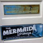 Sign on the door of one boathouse invites land lovers to use the &ldquo;side door.&rdquo;                                Terryl Asla/Kitsap News Group