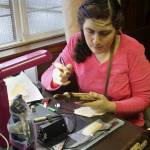 Artist April Shelton works on a simple pyrographic image on a rolling pin.                                Terryl Asla / Kitsap News Group