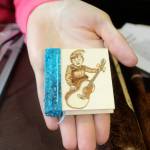 Here&rsquo;s an example of one of April Shelton&rsquo;s tiny, handmade books. She decorates the wooden covers and gives them away to children in memory of her late father. She learned book making at the Port Orchard Library.                                Terryl Asla / Kitsap News Group