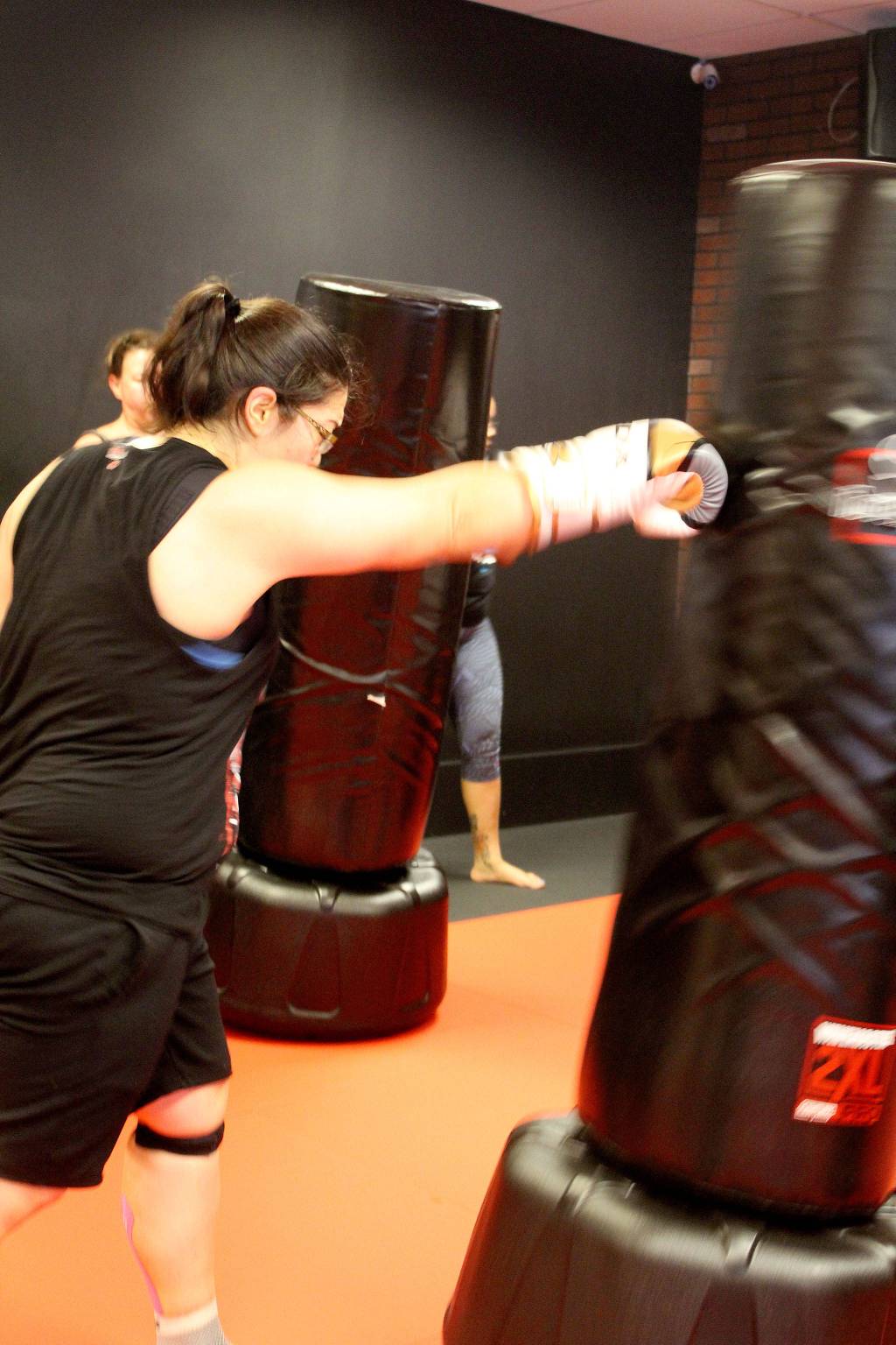 Classes at iLoveKickboxing are high energy, high intensity workouts, which up to about 30 people can participate in at a time. Throughout the classes, instructors go around helping people correct their form and encouraging them to keep pushing.                                Michelle Beahm / Kitsap News Group