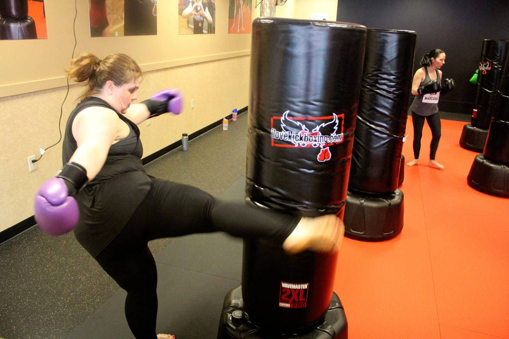 Classes at iLoveKickboxing are high energy, high intensity workouts, which up to about 30 people can participate in at a time. Throughout the classes, instructors go around helping people correct their form and encouraging them to keep pushing.                                Michelle Beahm / Kitsap News Group