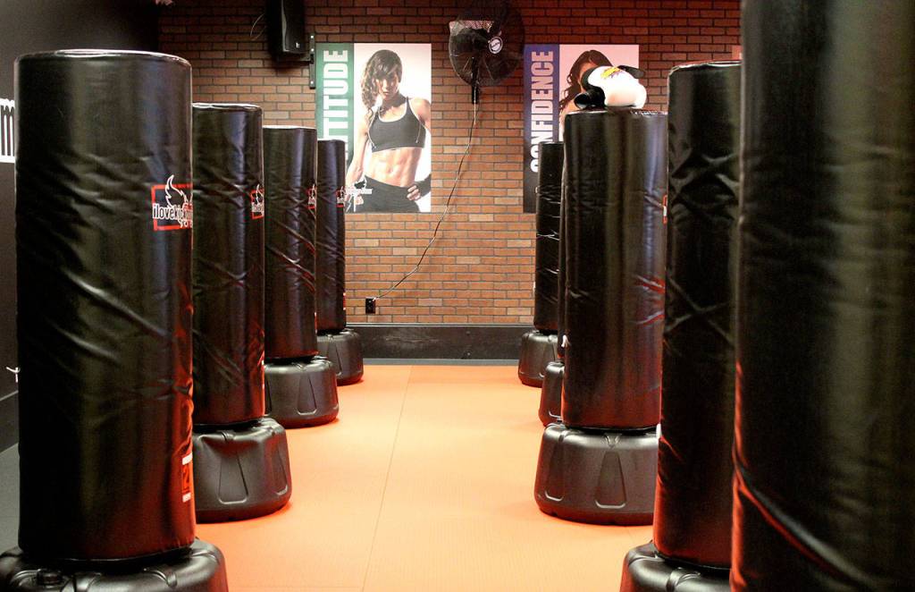 Everybody gets to use a bag during the classes at iLoveKickboxing, giving them resistance to help improve the workout.                                Michelle Beahm / Kitsap News Group