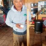 Ed Carriere stands in his home with his hand carved baseball bat and ball from the first game played on the baseball field in 1991. (Ed Carriere / Contributed)