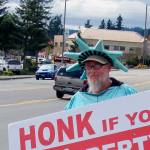 Larry Stigall is a sign waver. To do his three-hour shift, he has to ride nearly five hours on the bus.                                Terryl Asla/Kitsap News Group