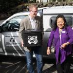 Rep. Kilmer holds a hot meal box as he and Meals on Wheels Kitsap Executive Director Deborah Horn prepare to drive to Ed&rsquo;s home. (Terryl Asla/Kitsap News Group)