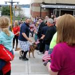 Air Force TSgt. Daniel Fye and his service dog, Susie, were surrounded by well-wishers after Fye and his family arrived in a motorcade. (Terryl Asla/ Kitsap News Group)