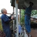 Members of the Port Orchard Rotary club make repairs to the Etta Turner Park gazebo next to the bridge at Blackjack Creek.