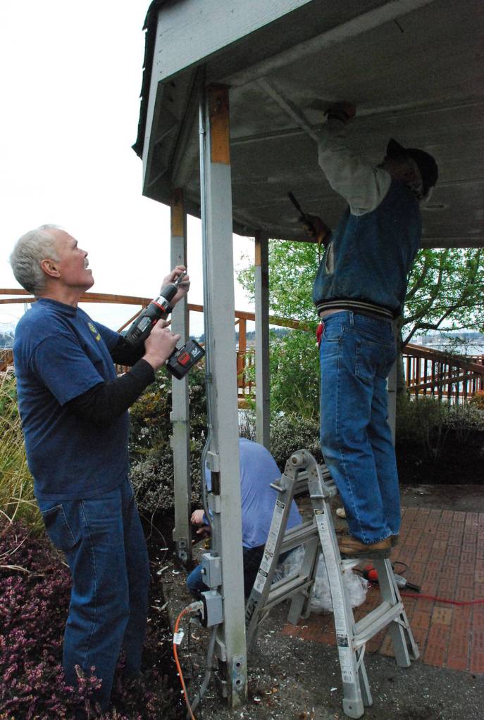 Members of the Port Orchard Rotary club make repairs to the Etta Turner Park gazebo next to the bridge at Blackjack Creek.