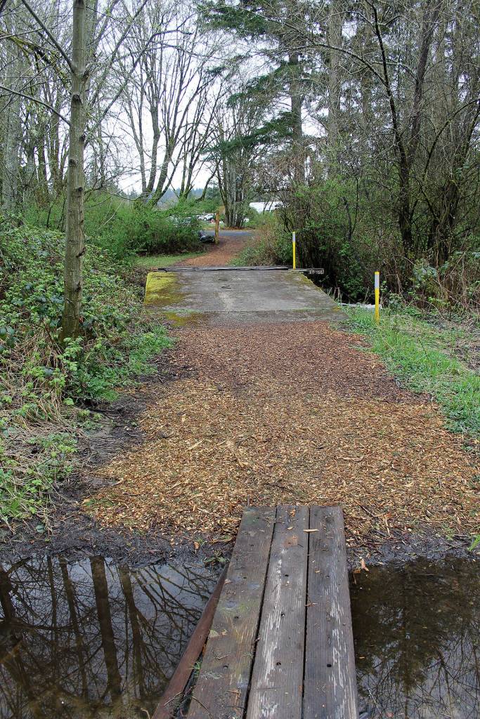 The City of Poulsbo is acquiring 2.68 acres at 20831 Bond Road NE for $1. The property was abandoned and Freddie Mac foreclosed on it. A flood-prone house near Dogfish Creek will be removed and the acreage added to Fish Park. Terryl Asla/Kitsap News Group