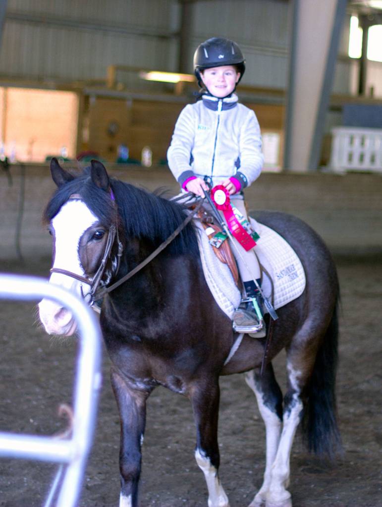 Kira O&rsquo;Malley poses with her ribbons from the Sandamar Farm Winter Series show, April 15. (Sophie Bonomi / Kitsap News Group)