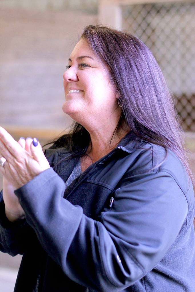 Tracy Patterson applauds competitors during the Sandamar Farm Winter Series show, April 15. (Sophie Bonomi / Kitsap News Group)