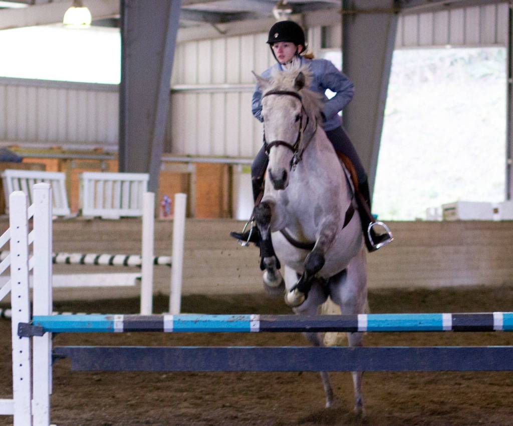 Jada Hertz, 14, and Hugo sail over a 2-foot-9-inch jump during an English event at Sandamar Farm April 15. (Sophie Bonomi / Kitsap Daily News)