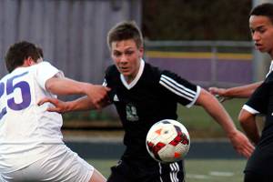 Klahowya and North Kitsap players battle for possession March 30, at North Kitsap. The game ended in a 1-1 tie. Sophie Bonomi/Kitsap News Group