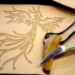 A handmade knife and a hand carved design in leather that will be turned into a mug.                                Michelle Beahm / Kitsap News Group