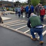 Area volunteers begin work to frame a stud wall for one of the three cottages being built to house homeless residents in South Kitsap.                                Bob Smith | Kitsap News Group