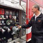 Steve Wright, South Kitsap Fire and Rescue fire chief, points out the pump controls for one of the district&rsquo;s new fire engines. Photo credit: Bob Smith | Kitsap Daily News