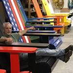 Doug Woodside sits in one of 12 large Adirondack chairs that are part of a branding effort in Kingston. (Susan Rodgers/Contributed)