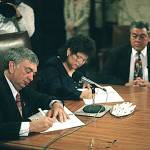 Gov. Mike Lowry and Quinault Nation President Pearl Capoeman Baller sign the compact related to the Quinault Beach Resort & Casino. Looking on is Quinault Councilman Ray Lorton. (Larry Workman/Quinault Nation)
