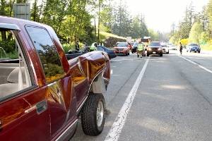 A car and a pickup truck collided shortly before 5 p.m. in the southbound lane of Highway 305, May 22. A Lemolo man said he was driving &ldquo;traffic speed at best&rdquo; but believes he passed out from fatigue and heat. When he came to, he said, his car had crashed into a pickup truck and then a guardrail. (Richard Walker/Kitsap News Group)