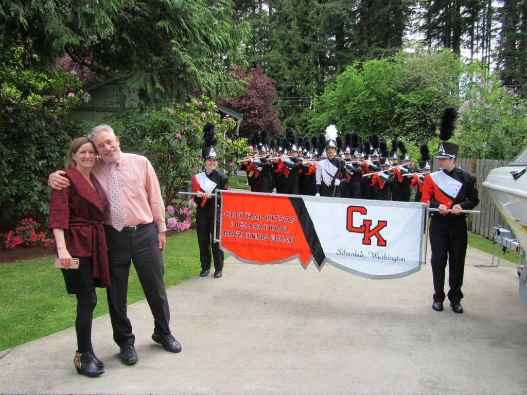 Principal Coons and his wife pose with the band. Terryl Asla/Kitsap News Group