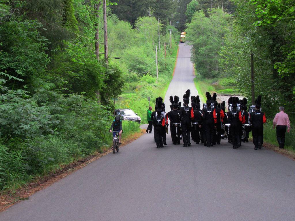 Principal Coons walked back with the band to their waiting busses, followed by a youthful music lover. Terryl Asla/Kitsap News Group